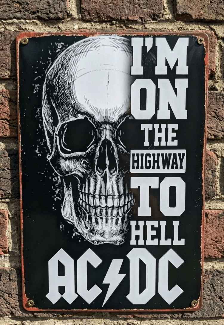 Vertical metal wall sign featuring a detailed white skull on a black background with the text I'M ON THE HIGHWAY TO HELL and the iconic AC/DC lightning bolt logo