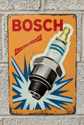 Vintage-style orange metal wall sign for Bosch Spark Plugs featuring a large spark plug illustration with a blue burst effect, the Bosch logo, and distressed rusted edges