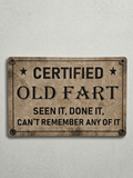 Vintage-style tan metal novelty wall sign with the text 'CERTIFIED OLD FART' and the humorous slogan 'SEEN IT, DONE IT, CAN'T REMEMBER ANY OF IT' with aged, distressed textures.