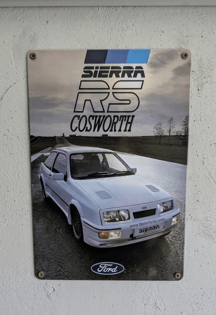 Metal wall sign featuring a high-definition photograph of a white Ford Sierra RS Cosworth on a track, with the RS Cosworth logo and Ford oval branding.