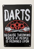 Vertical black metal wall sign with the text 'DARTS BECAUSE THROWING ROCKS AT PEOPLE IS FROWNED UPON' in white distressed typography, featuring an illustration of a red and black dartboard with two crossed darts.