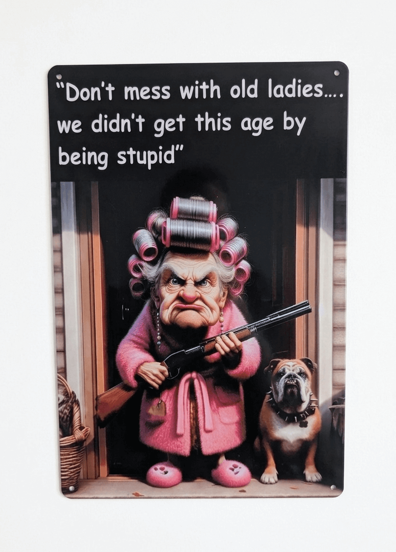 Funny metal wall sign featuring a cheeky grandmother in pink dressing gown with a bulldog and a shotgun, with the quote Don't mess with old ladies