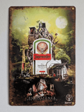 Vertical vintage-style metal wall sign for Jägermeister in protective plastic wrap, featuring a highly detailed, surreal fantasy landscape illustration titled 'SUBSISTENCE' by Rusalka Design, centered around a classic herbal liqueur bottle with heavy faux-rust distressed borders.