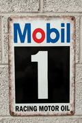Vintage-style vertical metal wall sign for Mobil 1 Racing Motor Oil featuring the blue and red Mobil logo above a large white number 1 on a black block, with distressed rusted edges