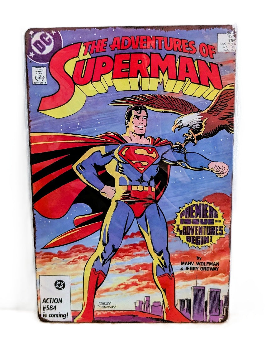 Vertical vintage-style metal wall sign featuring the cover of The Adventures of Superman comic, with Superman standing heroically as an eagle flies toward him, set against a sunset sky and city skyline with rusted, distressed edges.