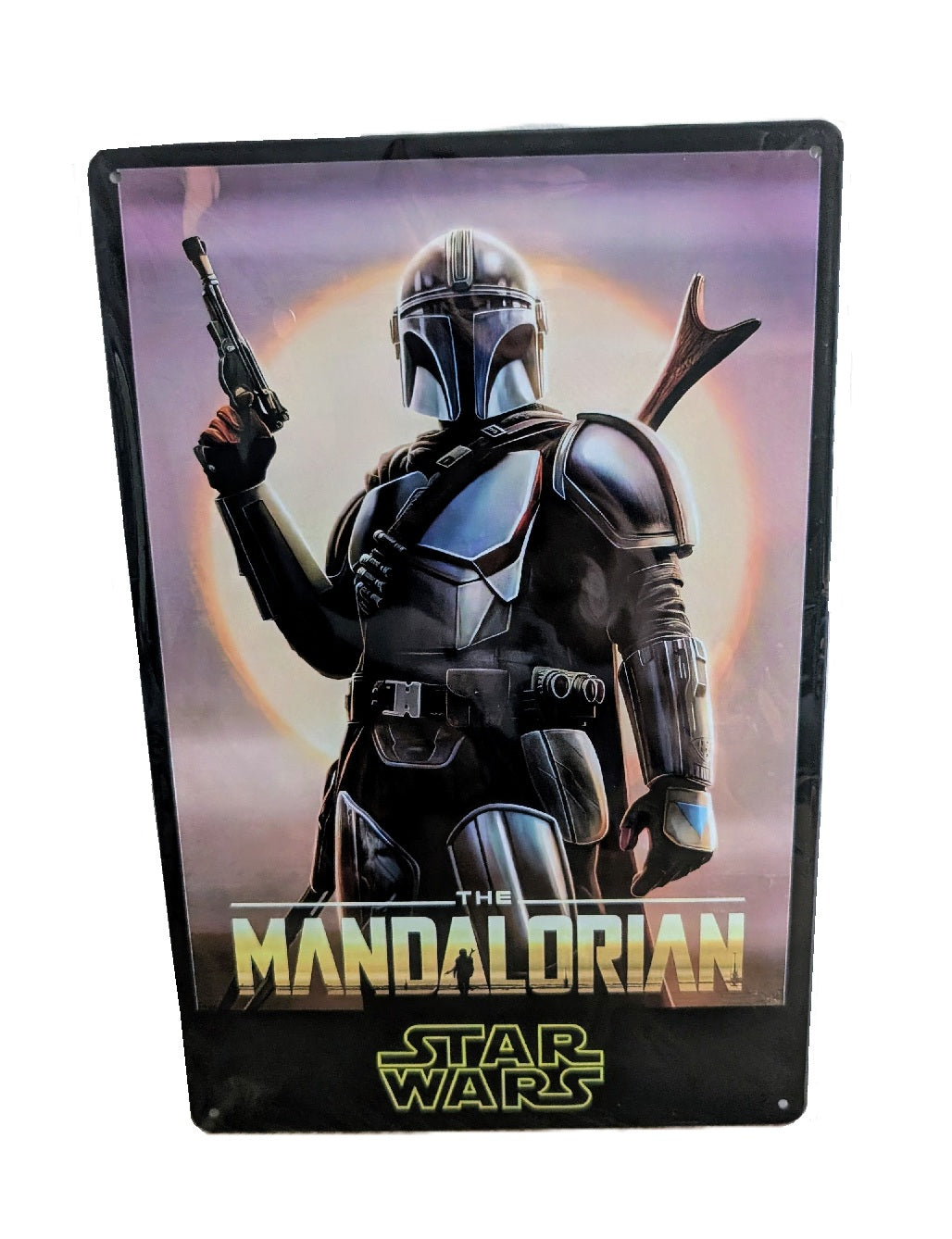 Metal wall sign featuring Din Djarin from The Mandalorian in full Beskar armor, holding a blaster against a glowing sun background with the Star Wars logo