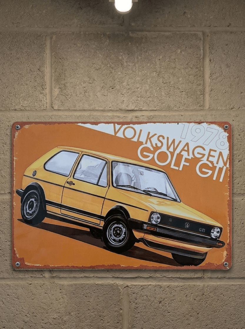 Vintage-style landscape metal wall sign for a 1978 Volkswagen Golf GTI, featuring a yellow Mk1 model against a bold orange and white background with heavily rusted, weathered edges.