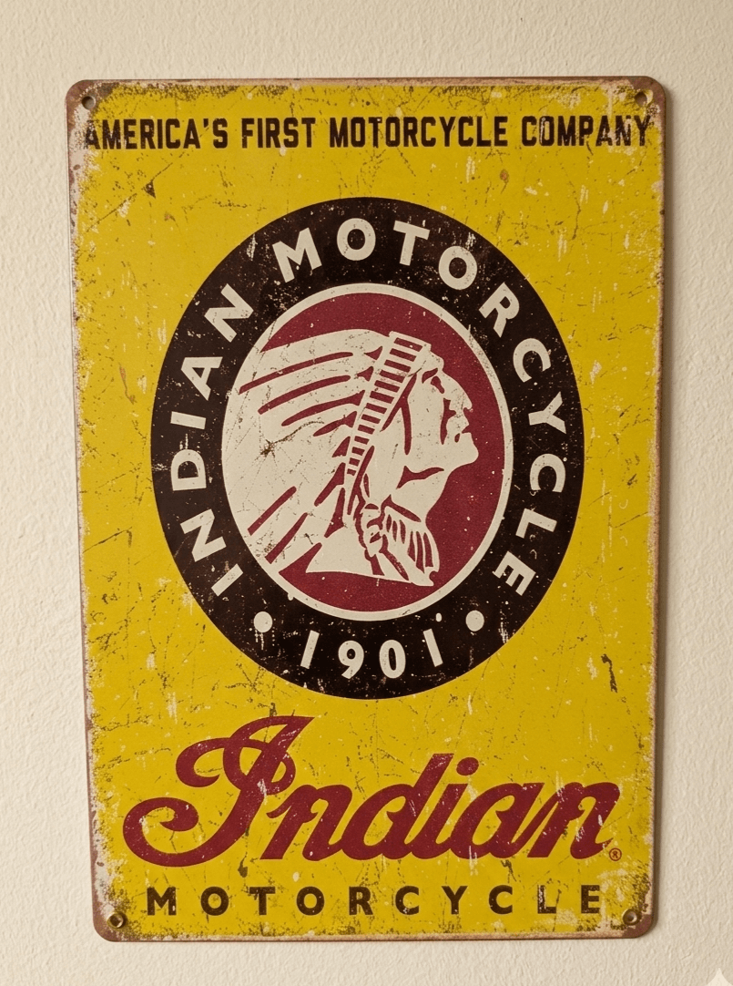 Vintage-style yellow metal sign featuring the circular Indian Motorcycle 1901 logo and script with heavy distressing and scratches