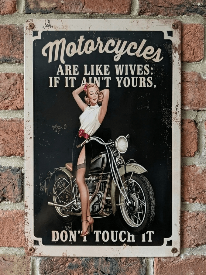 Vintage-style vertical metal wall sign featuring a pin-up woman posing with a classic motorcycle and the humorous text 'Motorcycles Are Like Wives: If It Ain’t Yours, Don’t Touch It' on a distressed black and cream background.