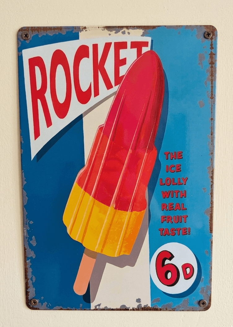 Vintage-style vertical metal wall sign for a Rocket ice lolly, featuring the iconic red, orange, and yellow lolly against a blue and white striped background with '6d' pricing and weathered edges.