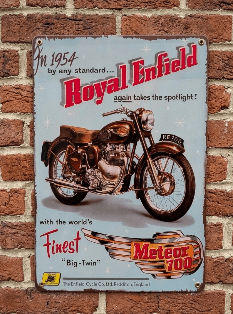 Vintage-style light blue metal wall sign featuring a 1954 Royal Enfield Meteor 700 motorcycle advertisement with a distressed, rusted border