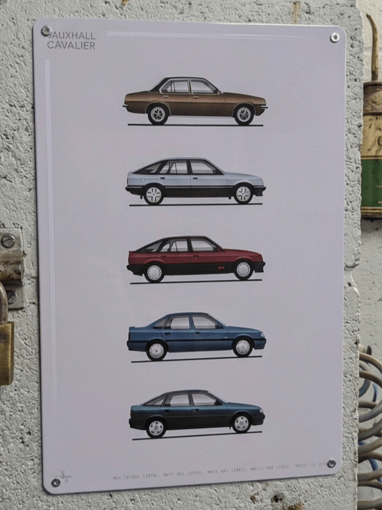 Vertical white metal wall sign mounted on a textured garage wall, showcasing a detailed graphic evolution of five classic Vauxhall Cavalier models from the Mk1 to the Mk3 in profile view, featuring bold 'Vauxhall Cavalier' text in the top left and model specifications printed along the bottom edge.