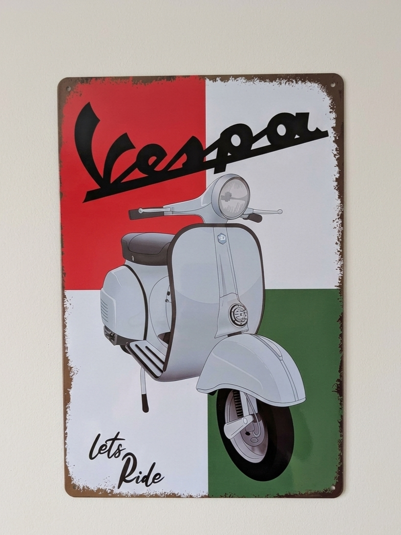 Vintage-style metal wall sign featuring a classic white Vespa scooter against a red, white, and green Italian flag background with the text Vespa and Lets Ride