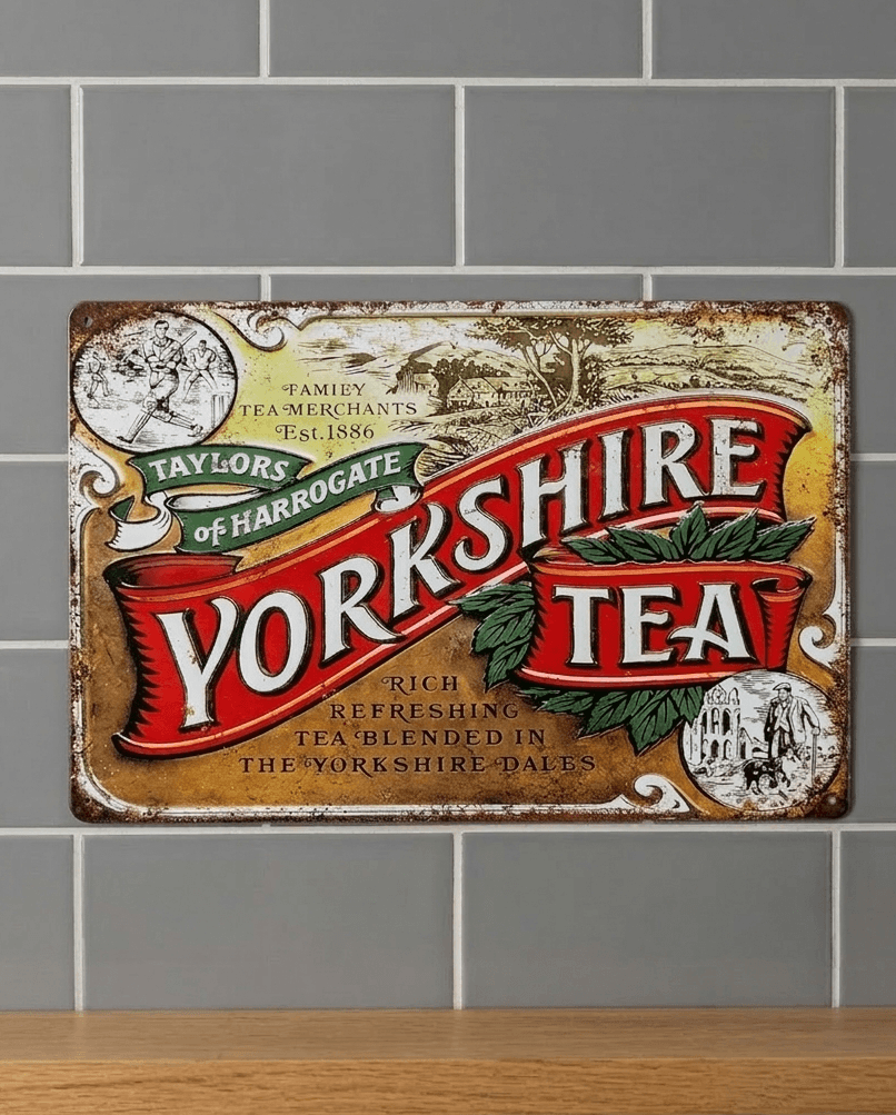 Vintage-style landscape metal wall sign for Yorkshire Tea by Taylors of Harrogate, featuring classic red banner typography, tea leaf illustrations, and pastoral sketches on a heavily distressed, tea-stained background